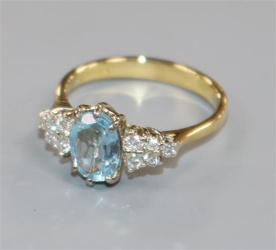 A modern 18ct gold, aquamarine and diamond set dress ring, size N.